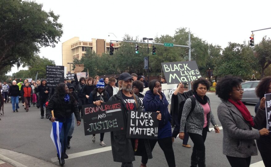 Protesters march down University Avenue toward 13th Street. The march blocked both lanes of west-bound traffic.