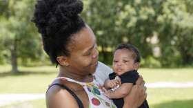 Venessa Aiken holds her son Jahzir Robinson, five weeks old, outside their home Sunday, Aug. 21, 2022, in Orlando, Fla. States around the country are making it easier for newborn moms to keep Medicaid in the year after childbirth, a crucial time when depression and other health problems can develop.(AP Photo/John Raoux)