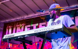 A man plays a keyboard on stage