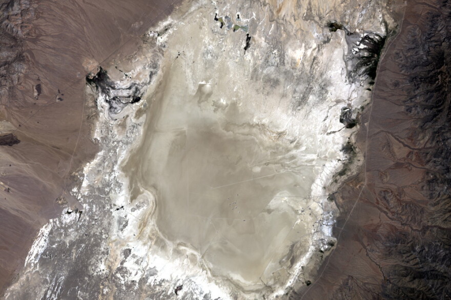 In this undated photo provided by NASA, a satellite captures the Railroad Valley (RRV), a dry lakebed in Nevada, for conducting ground-based calibration of Earth-observing satellite instruments. At the request of NASA, U.S. land managers have withdrawn about 36 square miles of federal land otherwise open to mineral exploration and mining at the site 250 miles northeast of Las Vegas. Nevada Republican Rep. Mark Amodei has introduced legislation that would rescind the land withdrawal and potentially reopen it to mining. (NASA via AP)