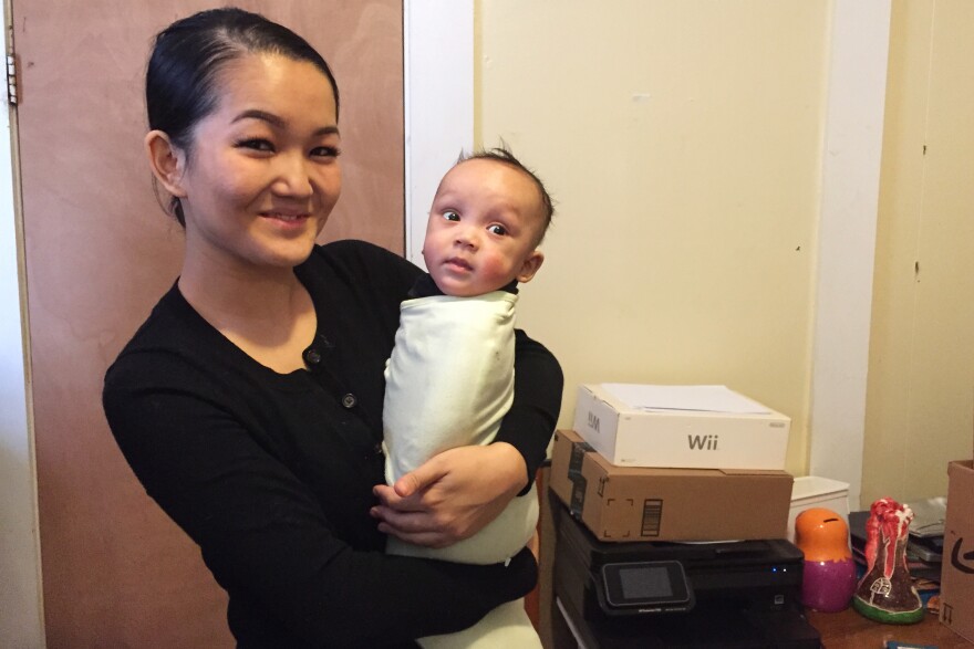 Madina Tagasheva, holding her 4-month-old son, Kareem, plans to apply for one of the new deferred action programs if they are approved by the courts.