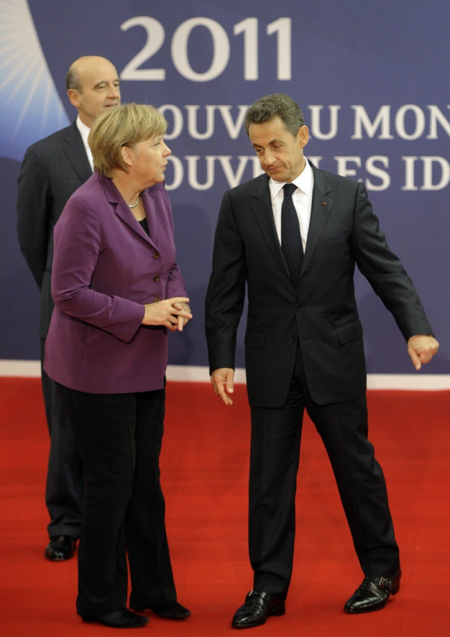 German Chancellor Angela Merkel talks to French President Nicolas Sarkozy on the eve of the G-20 summit in Cannes, France, earlier today.