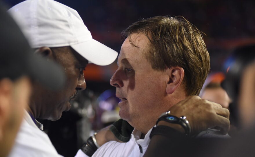 Florida head coach Jim McElwain shakes hands with East Carolina head coach Ruffin McNeill after the game.