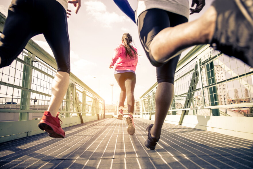  Three runners sprinting outdoors 