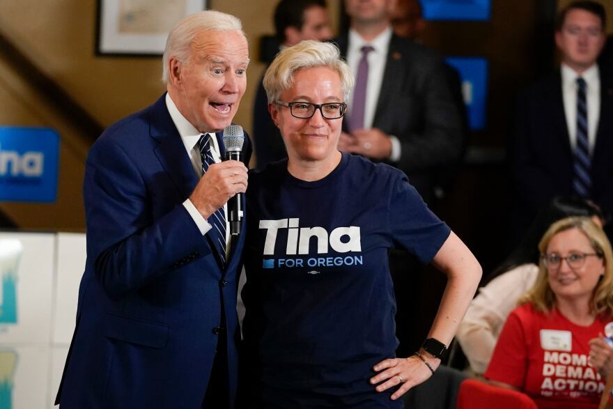 President Joe Biden stands with Tina Kotek, the Oregon Democratic nominee for governor, as he speaks during a grassroots volunteer event with the Oregon Democrats at the SEIU Local 49 in Portland, Ore. Friday, Oct. 14, 2022.