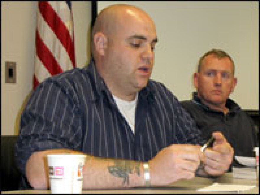 Jay White, the discussion moderator, looks on as veteran Aaron Jones, 28 (left), talks about his experiences in Iraq and back home in Connecticut.