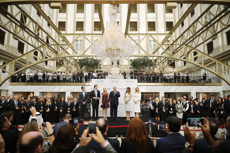 Then-presidential candidate Donald Trump (C) and his family prepare to cut the ribbon at the new Trump International Hotel on October 26, 2016, in Washington, D.C.