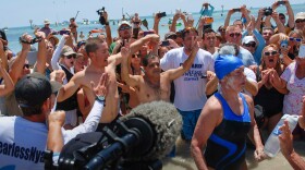 Diana Nyad completes the last few steps of her 110-mile swim from Havana, Cuba, to Key West, Florida, Monday, September 2, 2013.