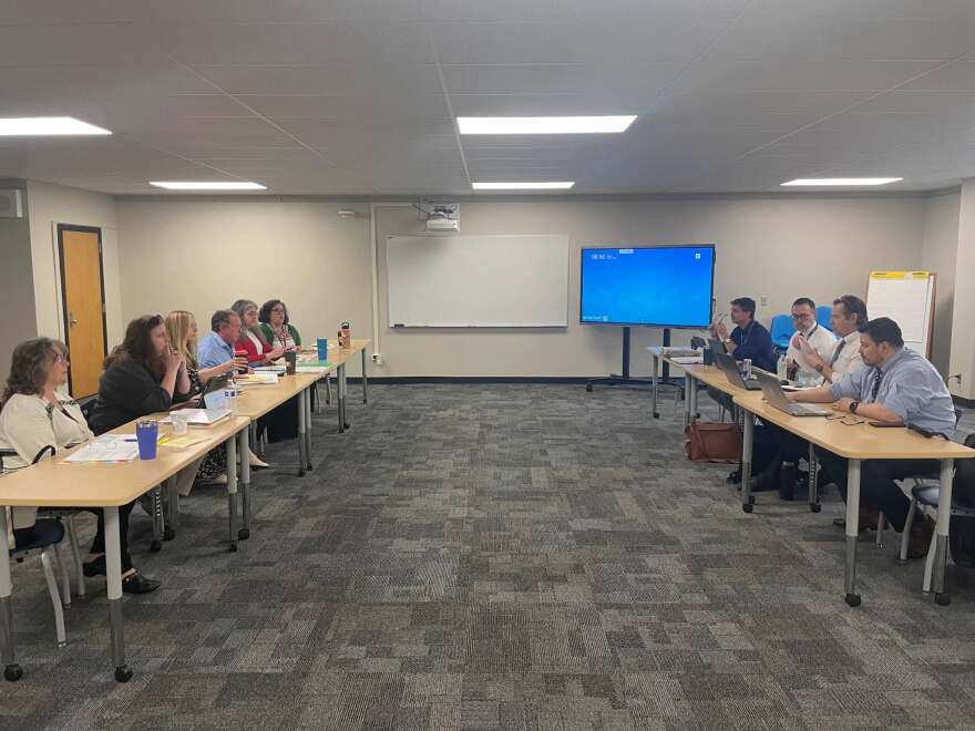 Members of United Teachers of Wichita's negotiating team (left) discuss proposals for a new teacher contract with members of the Wichita Board of Education's negotiating team during a meeting in April.