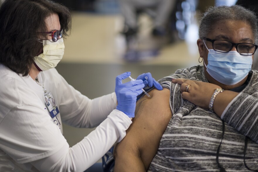 A patient receives a COVID-19 vaccine at a Novant Health clinic at Spectrum Center on Feb. 13.