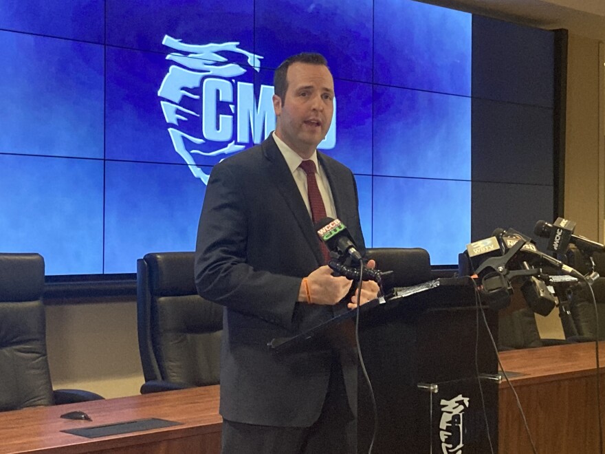 CMPD Lt. Bryan Crum speaks at a news conference Friday announcing the arrests of two people in connection with the two recent homicides.