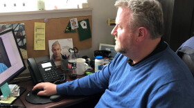 Dr. Craig Dietz, the chief medical office at KC Care Health Center, uses a computer to meet with a patient.