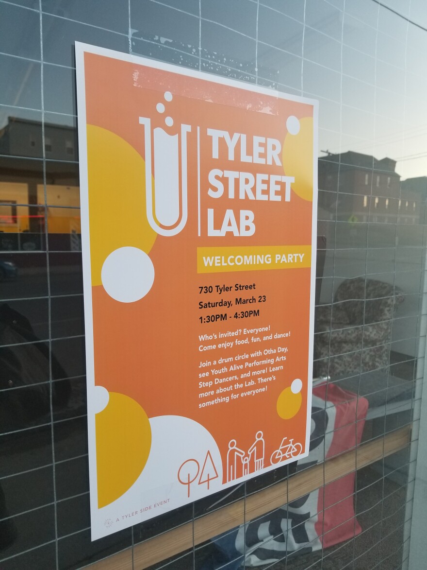 A photo of the orange and white flyer for the Tyler Street Lab's March 23rd launch party.