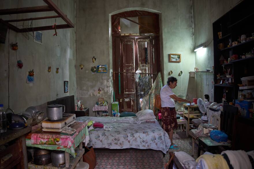 Mercedes Lopez Rey, 83, stands in her one-room apartment in Old Havana, Cuba, Friday, April 10, 2026.