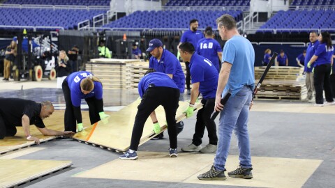 A crew assembles the NCAA Men's Final Four court at Lucas Oil Stadium.