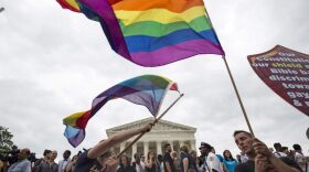 FILE PHOTO: Supporters of gay marriage wave the rainbow flag after the U.S. Supreme Court ruled on Friday that the U.S. Constitution provides same-sex couples the right to marry at the Supreme Court in Washington June 26, 2015. REUTERS/Joshua Roberts/File Photo