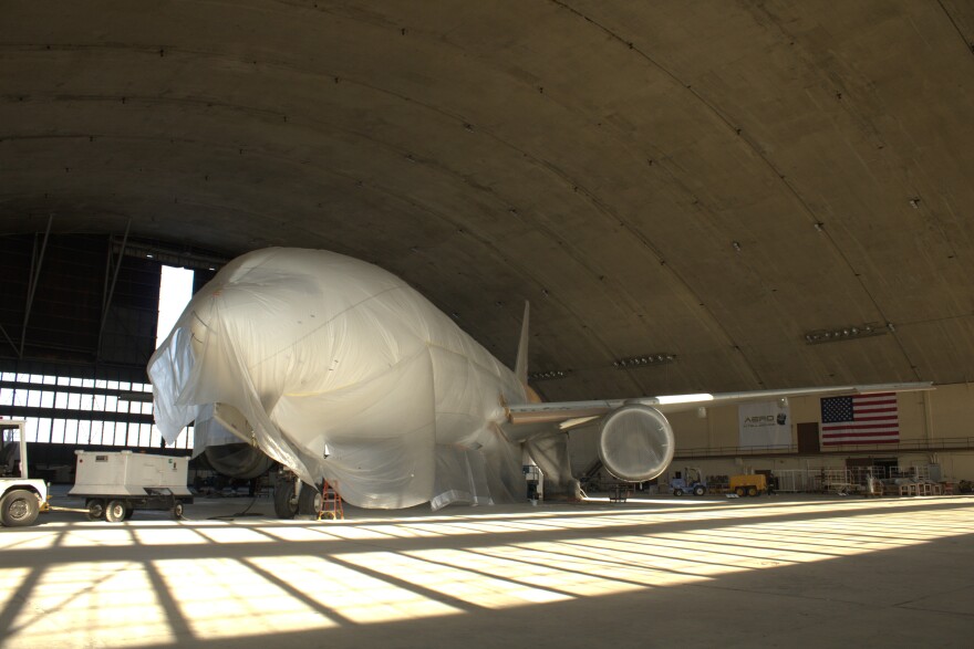 A Boeing 777 passenger jet sits in the Loring's historic Arch Hangar on Nov. 19, 2025. The jet is being retrofit for a new customer by Aero Intelligence, one of Loring's newest businesses.