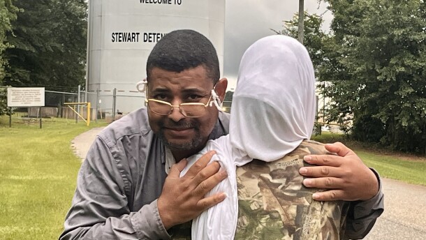 Image shows Mohamed Naser hugging his 15-year-old daughter