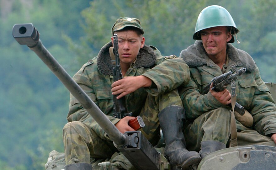 Russian soldiers sit atop a military vehicle in the disputed South Ossetia region in August 2008. The nine-day conflict between Russia and Georgia was accompanied by a cyberattack.