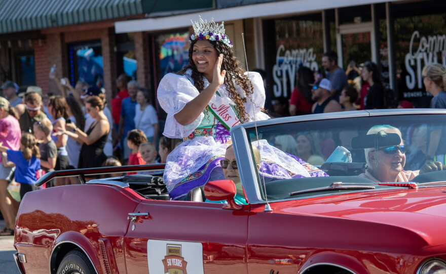 Miss Westfest 2026 Kierstyn Powers waves to the crowd during the Westfest parade on Saturday. As part of the 50th anniversary celebrations, the parade also included a float featuring past winners of the Miss Westfest pageant.