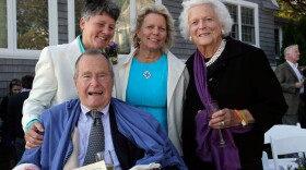 In this Sept. 21, 2013 photo, former President George H.W. Bush, front left, former first lady Barbara Bush, right, pose for photos after the wedding of longtime friends Helen Thorgalsen, center, and Bonnie Clement, in Kennebunkport, Maine. Bush was an official witness at the same-sex wedding, his spokesman said Wednesday, Sept. 25, 2013. (Susan Biddle/AP)