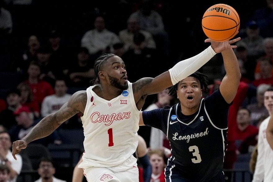 Houston guard Jamal Shead (1) grabs a loose ball away from Longwood guard DA Houston (3) during the first half of a first-round college basketball game in the NCAA Tournament, Friday, March 22, 2024, in Memphis, Tenn. 