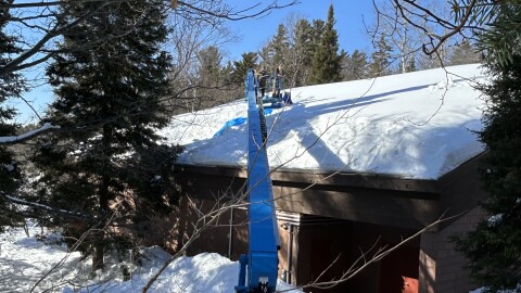To avoid putting extra weight on the roof, an extended lift was used to remove the snow from the roof.