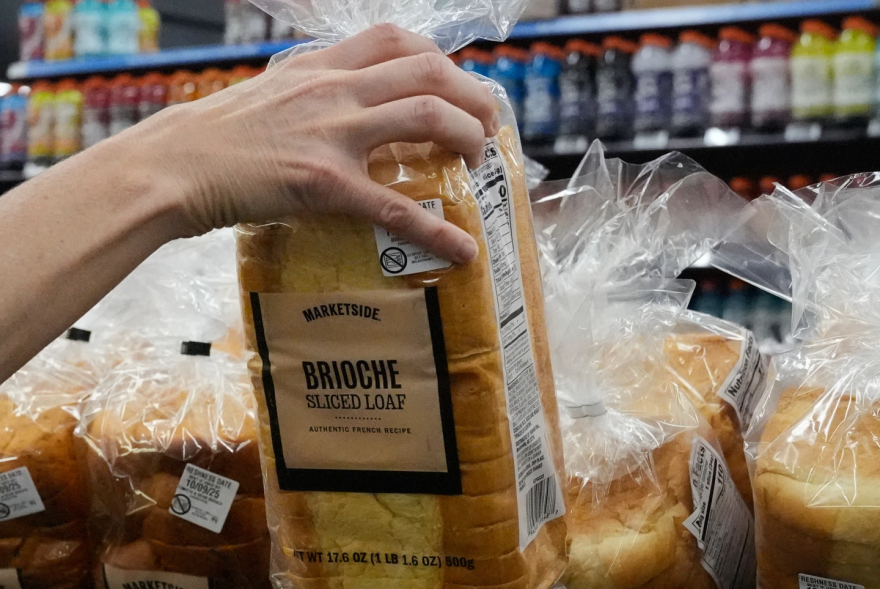 A customer reaches for a loaf of Marketside brand bread at a Walmart Neighborhood Market, Friday, Sept. 26, 2025, in Bentonville, Ark.