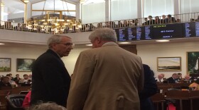 Two Cumberland County representatives, Republican John Szoka, left, and Democrat Billy Richardson, talking during Wednesday's house session at the North Carolina General Assembly. House Republicans hope to win over some Democrats for an override of Gov. Roy Cooper's budget veto.