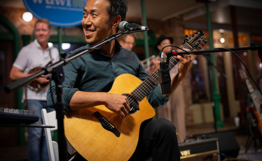 On September 3rd, 2026 international recording and touring artists Hiroya Tsukomoto, Chris Moyse, and John Common & Jess DeNicola performed for a packed house of Pensacola music enthusiasts for the NPR broadcast of WUWF’s RadioLive held at the Pensacola Museum of Commerce the first Thursday of each month. Photo Credit Elizabeth Linn © all rights reserved