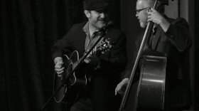 a black-and-white picture of Jon Shain with his guitar and FJ Ventre with his bass