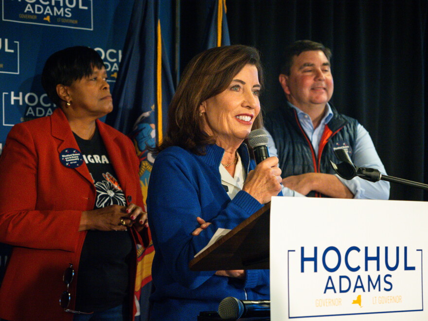 Governor Kathy Hochul speaks to a crowd, with U.S. Rep. John Mannion (NY-22) and Syracuse Mayor Sharon Owens behind her. 