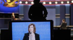 A student standing in for Democratic presidential nominee Hillary Clinton is captured on the large monitor during a rehearsal for the third presidential debate at UNLV in Las Vegas, Tuesday, Oct. 18, 2016.