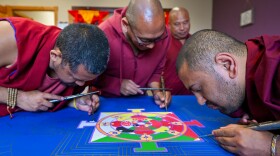 Venerable Shanu, Geshe Tsonyi, Venerable Surya create a White Parasol mandala, while Geshe Phuntsho looks on.