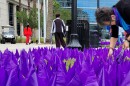Hubbard House CEO Gail Patin plants a row of purple flags in front of the Duval County Courthouse on Friday, Sept. 29, 2023. Each flag represents a victim of domestic abuse who filed an injunction against their abuser.
