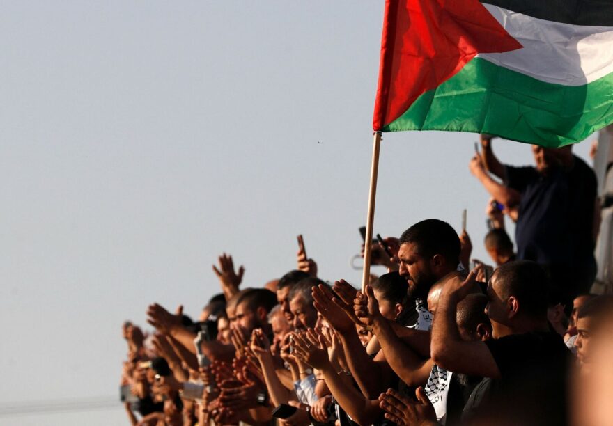 Mourners raise a Palestinian flag during the funeral of Mohammad Kiwan, a 17-year-old Palestinian who succumbed to his wounds after being shot during confrontations with Israeli troops last week, in the mostly Arab city of Umm al-Fahm in northern Israel.