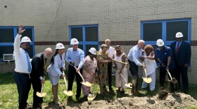 Community members and elected officials break ground on the People's Settlement Association's new community center.