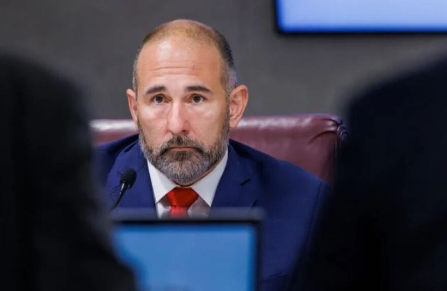 Jay Collins listening during a committee hearing