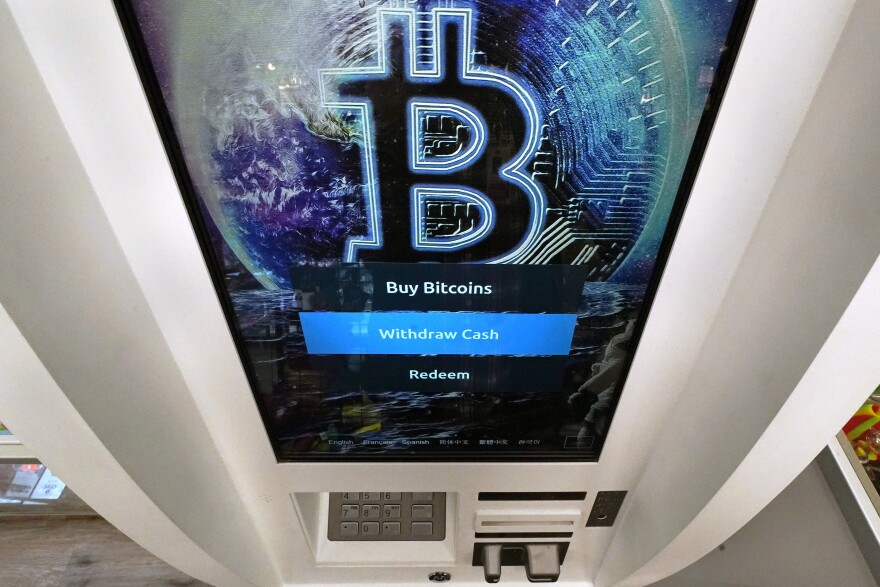 In this file image, a Bitcoin logo appears on the display screen of a cryptocurrency ATM in Salem, N.H., Feb. 9, 2021.