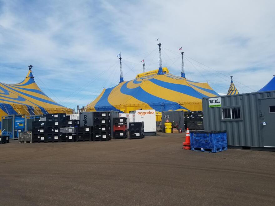 The show happens under a giant blue and yellow tent, which is set up in each new city.