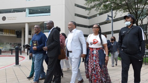 Attorney Ben Crump, second from left, walks with Ron Lacks, left, Alfred Lacks Carter, third from left, both grandsons of Henrietta Lacks, and other descendants of Lacks, outside the federal courthouse in Baltimore, Oct. 4, 2021.