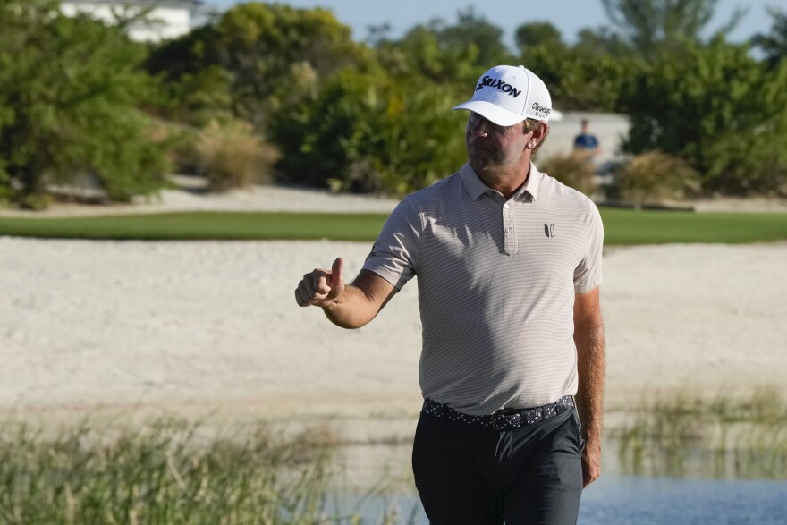 Lucas Glover, of the United States, flashes a thumbs up after hitting a hole-in-one on 17th hole during the second round of the Hero World Challenge PGA Tour at the Albany Golf Club, in New Providence, Bahamas, Friday, Dec. 1, 2023. (AP Photo/Fernando Llano)