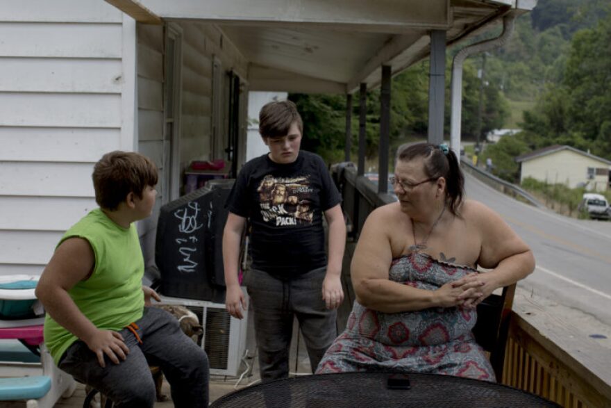 Terrie Caudill Jacobs, mother of Christopher Jacobs, talks with her grandsons sons Dakota Chase and Thomas Blake at their home in Pippa Passes, KY on August 2, 2021. Jacobs has been raising her grandsons full-time since her son, Christopher “Doughboy” Jacobs, died in 2017.