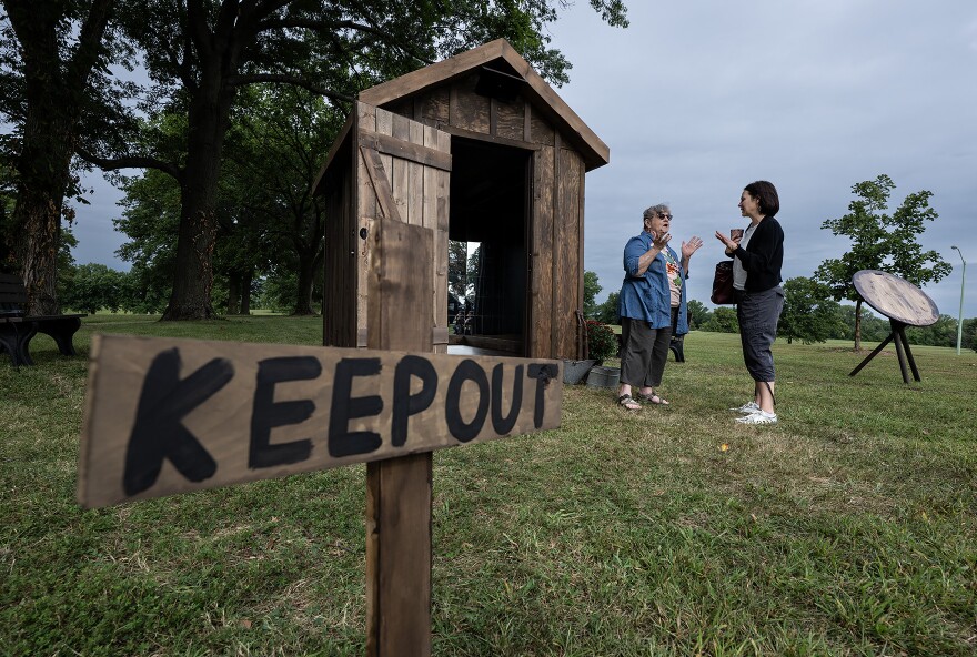 Omakyehstih Collective artist Smith, left, speaks with Neysa Page-Lieberman, founder and artistic director of Monumenta, the co-director of the project.
