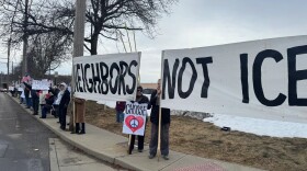 A group of protesters in Fairfield on Saturday team up to display a banner that says "Neighbors Not ICE."