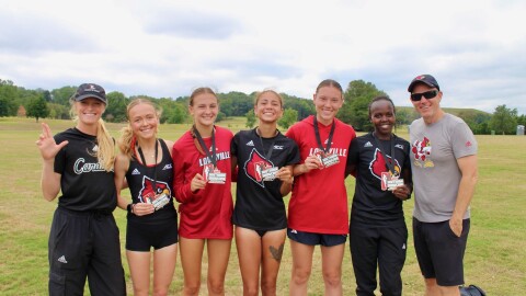The University of Louisville women's track team posing for a photo after a track meet