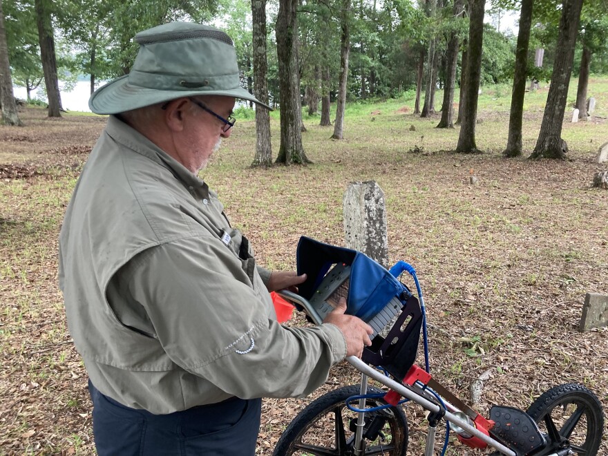 Len Strozier, of Omega Mapping Services, scans the Old Prewett Slave Cemetery in Northport, Alabama