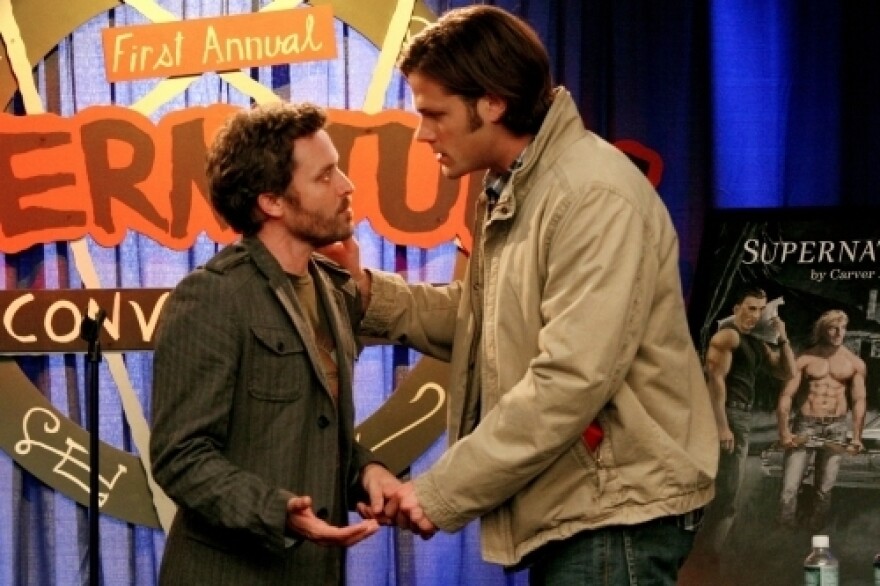 Jared Padalecki plays Sam Winchester (right), one of the stars of the series <em>Supernatural. </em>The Winchester brothers also star in the series-within-the-series, which is -- meta alert! -- also called <em>Supernatural. </em>Here, Sam talks to the (fictional) series author at a (fictional) convention for (fictional) rabid fans.