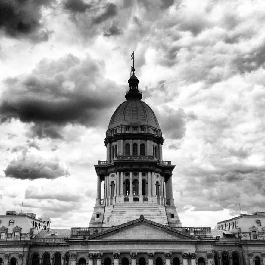 Illinois statehouse with storm clouds in the background