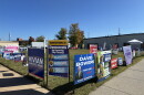 Signs adorn a street corner outside Roanoke's early voting site ahead of the 2026 election.